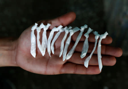 A member of MS-13 gang and drug dealer, shows small plastic bags containing cocaine in San Pedro Sula, Honduras, September 30, 2018. REUTERS/Goran Tomasevic