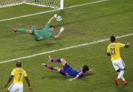 Japan's goalkeeper Eiji Kawashima fails to save a goal scored by Colombia's Jackson Martinez (R) during their 2014 World Cup Group C soccer match at the Pantanal arena in Cuiaba June 24, 2014. REUTERS/Suhaib Salem (BRAZIL - Tags: SOCCER SPORT WORLD CUP TPX IMAGES OF THE DAY)