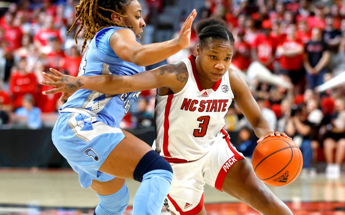 N.C. State’s Diamond Johnson (3) drives around North Carolina’s Kayla McPherson (14) during the second half of N.C. State’s 77-66 overtime victory over UNC at Reynolds Coliseum in Raleigh, N.C., Thursday, Feb. 16, 2023.