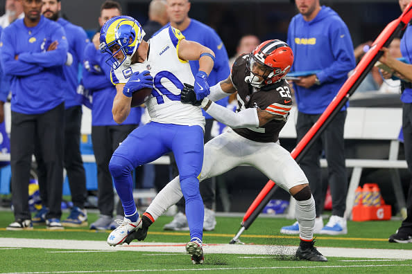 INGLEWOOD, CALIFORNIA – DECEMBER 03: Cooper Kupp #10 of the Los Angeles Rams runs with the ball while being tackled by Grant Delpit #22 of the Cleveland Browns in the third quarter at SoFi Stadium on December 03, 2023 in Inglewood, California. (Photo by Harry How/Getty Images)