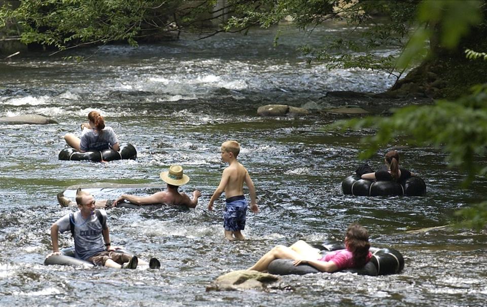 People cool-off in Deep Creek in this file photo in the Great Smoky Mountains National Park near Bryson City. A tubing trip is one of the many adventures for kids in the Asheville Parks and Recreation’s Summer Adventure Camp series.