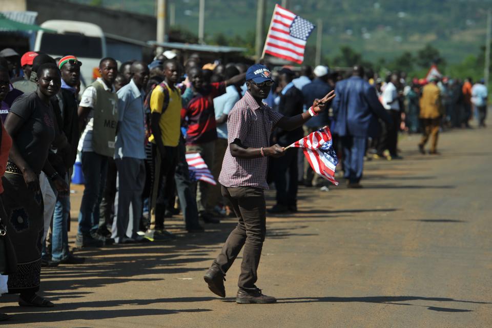 <p>Residents of Nyang’oma village in Kogelo wave US flags as they gather by the side of the road to wait for former US President, Barak Obama to arrive on July 16, 2018 for the opening of the Sauti Kuu Resource Centre, founded by his half-sister, Auma Obama at Kogelo in Siaya county, western Kenya. – Obama is in the East African nation for the first time since he left the US presidency and met with President Uhuru Kenyatta and opposition leader Raila Odinga in Nairobi. (Photo: Tony Karumba/AFP/Getty Images) </p>