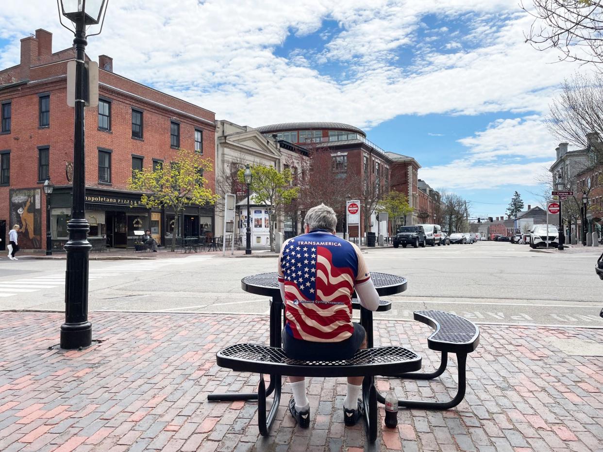 A man eats lunch in Portsmouth's Market Square Monday, April 29, 2024.