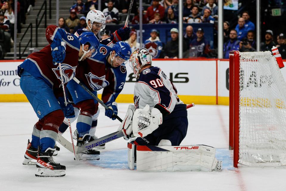 Mar 22, 2024; Denver, Colorado, USA; Colorado Avalanche center Ross Colton (20) pushes the puck past Columbus Blue Jackets goaltender Elvis Merzlikins (90) for a goal as left wing Miles Wood (28) and defenseman Damon Severson (78) look on in the second period at Ball Arena. Mandatory Credit: Isaiah J. Downing-USA TODAY Sports