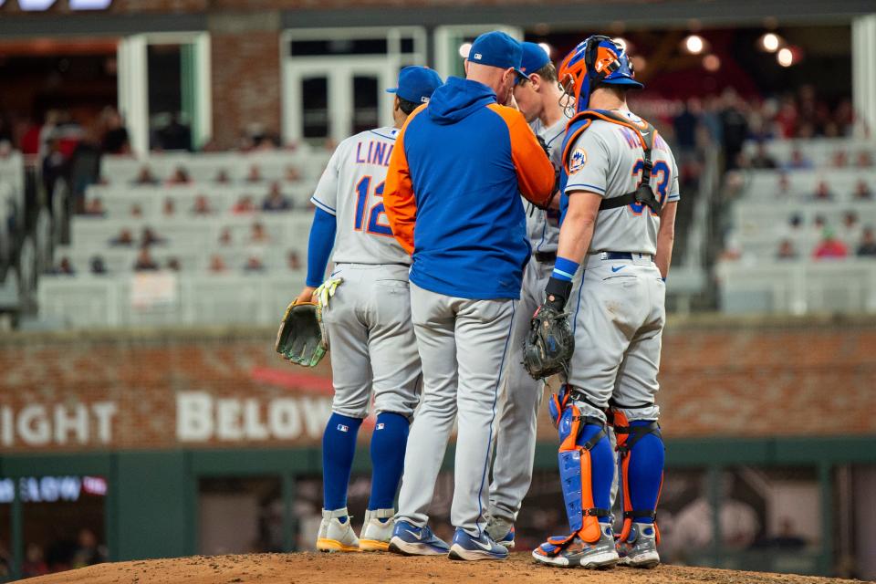 New York Mets pitching coach Jeremy Hefner center, makes a mound visit with catcher James McCann right, and shortstop Francisco Lindor left, to speak with starting pitcher Chris Bassitt on Sunday.