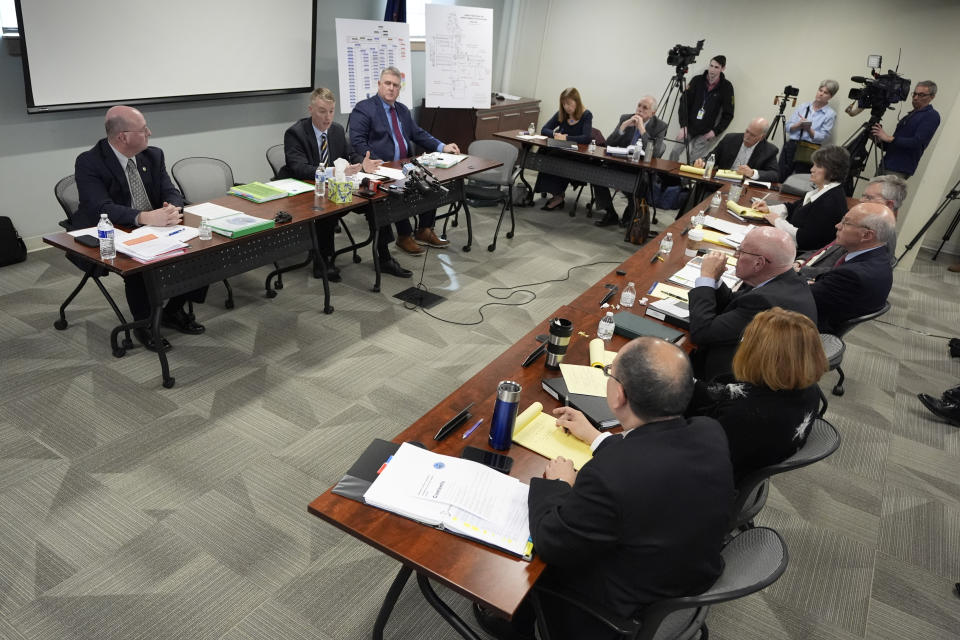 Major Lucas Hare of the Maine State Police, at top, second from left, testifies, Thursday, Feb. 15, 2024, in Augusta, Maine, during a hearing of the independent commission investigating the law enforcement response to the mass shooting in Lewiston, Maine. (AP Photo/Robert F. Bukaty)