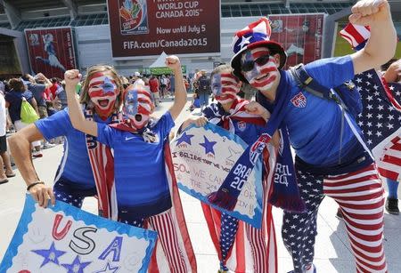 Jul 5, 2015; Vancouver, Alberta, CAN; United States fans Chantell and daughter Reiley Miles of Denver, Colorado, left, with Mike and daughter Sofia Holzer of Miami, Florida cheer outside B.C. Place Stadium before the final of the FIFA 2015 Women's World Cup between United States and Japan. Mandatory Credit: Erich Schlegel-USA TODAY Sports