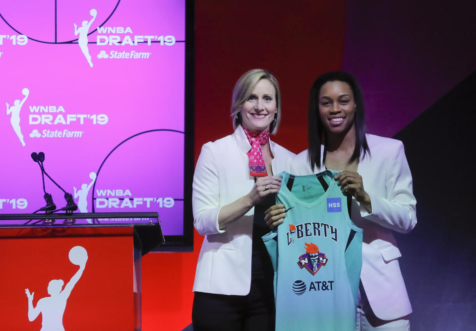 RETRANSMISSION TO CORRECT SPELLING OF NAME - Louisville's Asia Durr, right, poses for photo with WNBA COO Christy Hedgpeth after being selected by the New York Liberty as the second overall pick in the WNBA basketball draft, Wednesday, April 10, 2019, in New York. (AP Photo/Julie Jacobson)