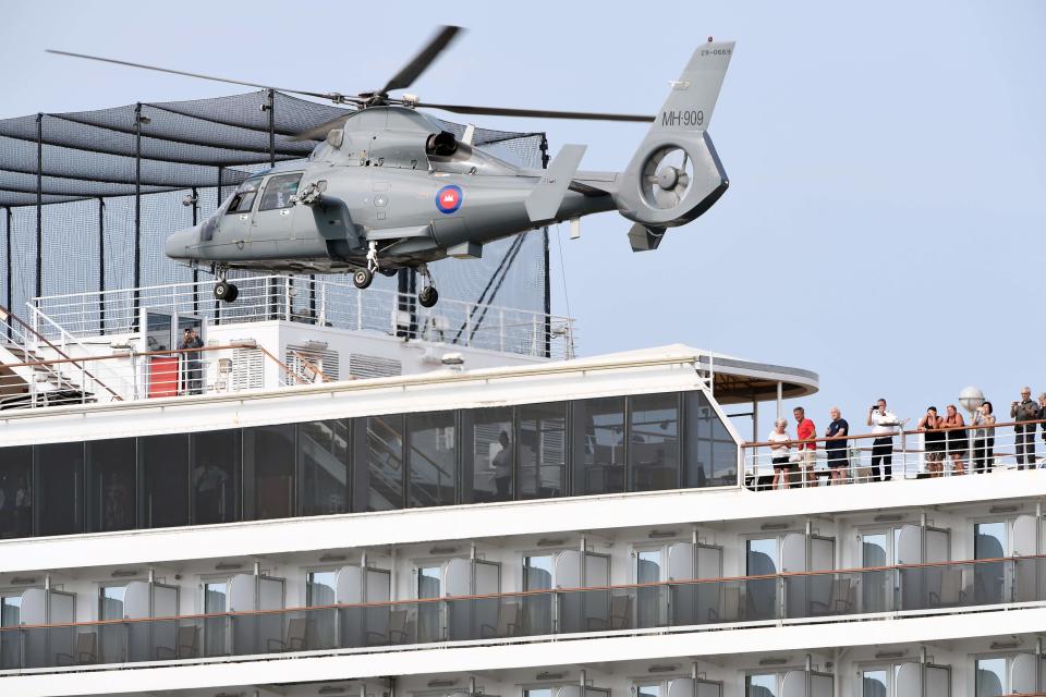 A helicopter takes off from the MS Westerdam Tuesday after Cambodian health officials checked to see whether any remaining passengers have the COVID-19 coronavirus.