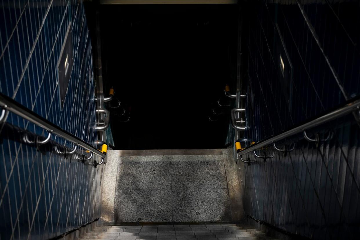 A stairway leads to a TTC station. The City of Toronto is extending a pilot program that sends outreach workers into the city’s transit system to respond to the growing number of homeless people using the indoor space for shelter. (Evan Mitsui/CBC - image credit)