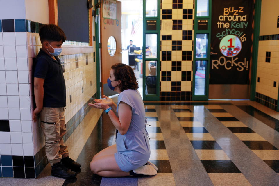 Instructional specialist Jessica Crane helps first grade student Dylan Lobo with some calming breathing exercises at the Kelly School, in Chelsea, Massachusetts, September 15, 2021. REUTERS/Brian Snyder