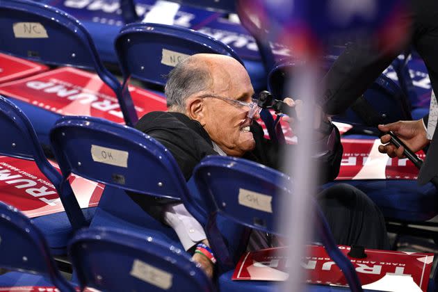 Former New York City Mayor Rudy Giuliani is helped to his feet after falling on the second day of the 2024 Republican National Convention in Milwaukee on July 16.