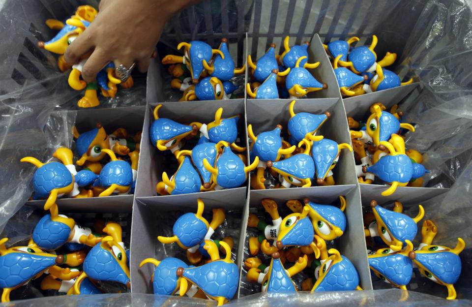 An employee makes toys of Fuleco the Armadillo, the official mascot of the FIFA 2014 World Cup, at a factory in Sao Bernardo do Campo February 27, 2014. The 2014 World Cup will be held in Brazil from June 12 through July 13. REUTERS/Paulo Whitaker (BRAZIL - Tags: SPORT SOCCER BUSINESS WORLD CUP SOCIETY)