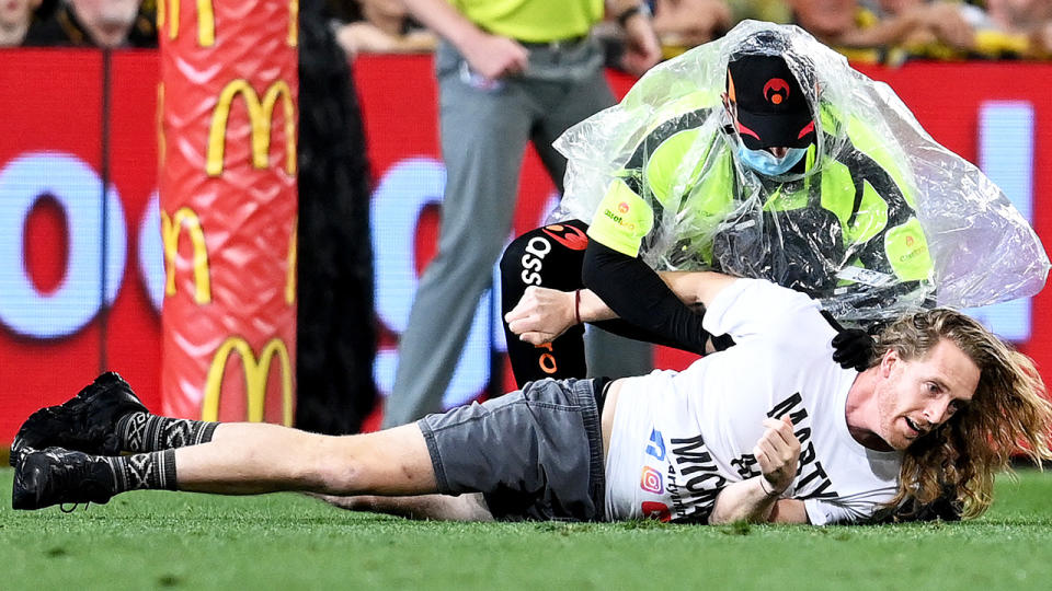 Two men who ran onto the field during the AFL Grand Final in October have been fined by a Brisbane magistrate. (Photo by Bradley Kanaris/AFL Photos/via Getty Images)