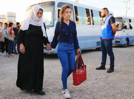 Syrian displaced families, who fled violence after the Turkish offensive against Syria, arrive at a refugee camp in Bardarash on the outskirts of Dohuk