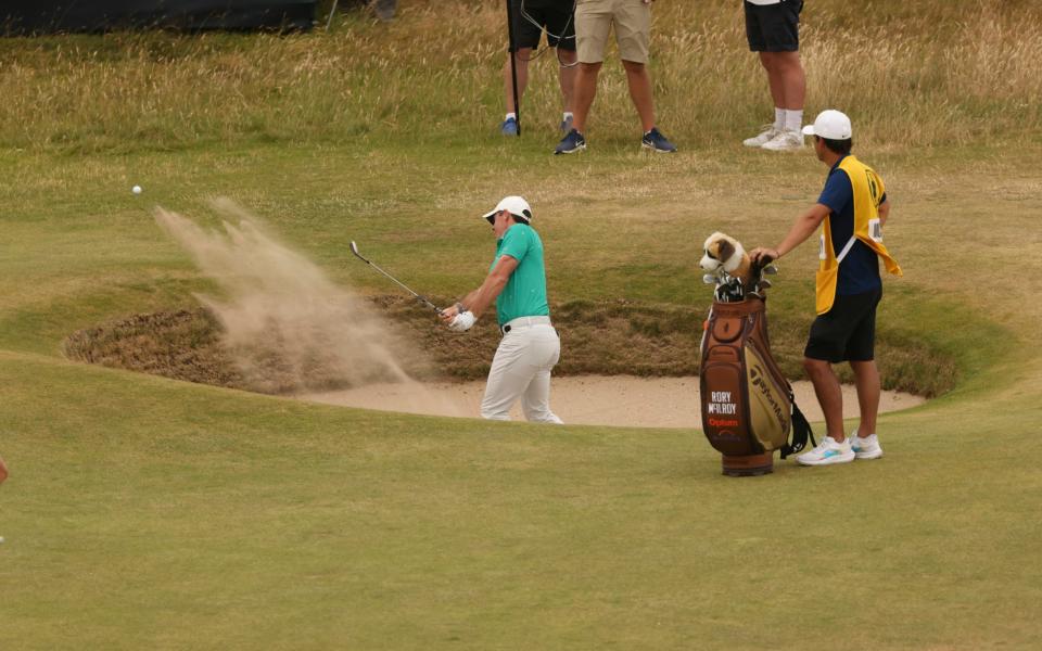 Rory McIlroy chips in from the bunker at the 10th for an eagle - AP