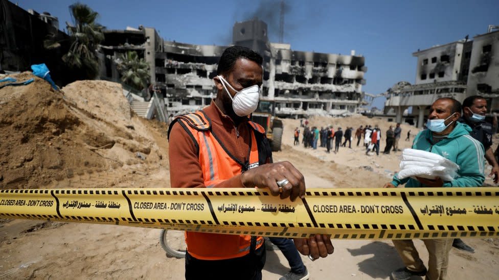 Palestinian officials tape off the courtyard of al-Shifa hospital in Gaza City as workers search for human remains (8 April 2024)