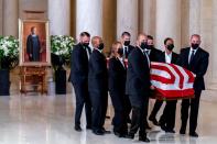 The flag-draped casket of Justice Ruth Bader Ginsburg arrives in the Great Hall at the Supreme Court in Washington