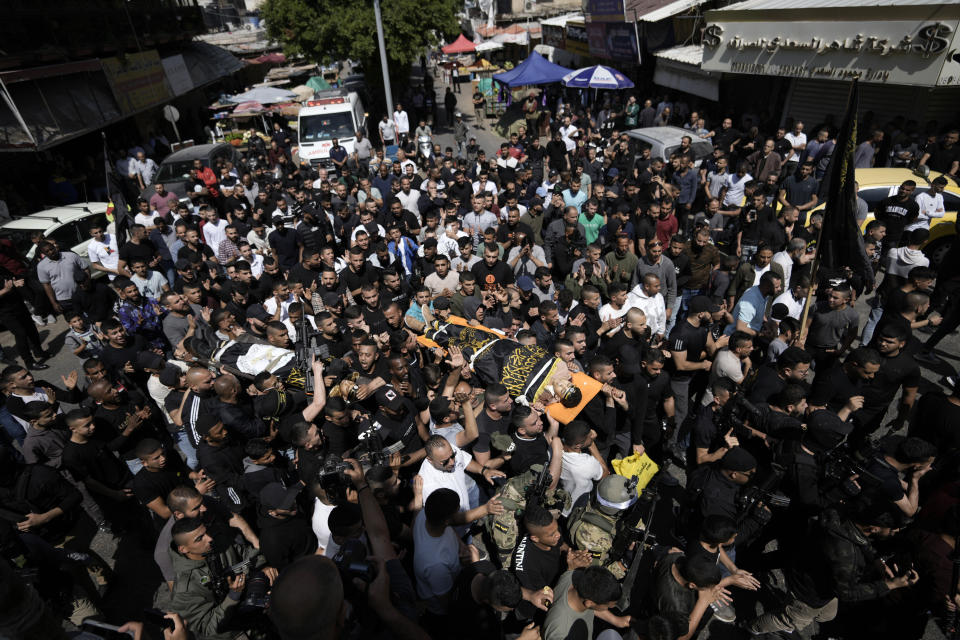 Mourners carry the bodies of Ahmed Assaf, 19, right, and Rani Qatanat, 24, draped in the flag of Islamic Jihad, two Palestinians killed by Israeli forces in Qabatiya, near the West Bank city of Jenin, Wednesday, May 10, 2023. The Israeli military said that Palestinian gunmen opened fire at troops in the Palestinian town of Qabatiya in the northern West Bank during an army raid. Troops returned fire, killing the two men, and confiscated their firearms, it said. (AP Photo/Majdi Mohammed)