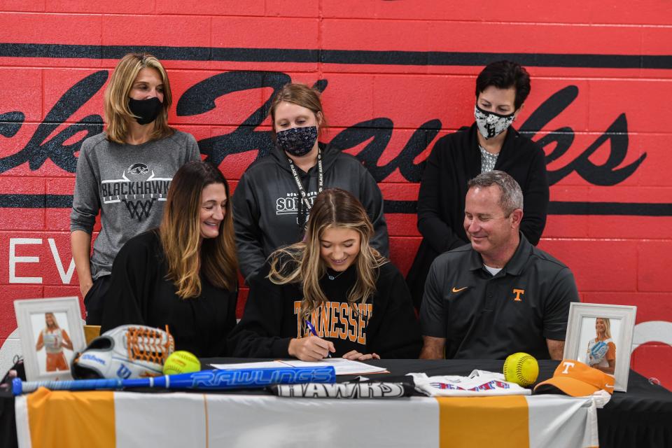 Alongside her parents and coaches, Karlyn Pickens signs to play softball for Tennessee on November 10, 2021.