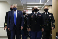 President Donald Trump wears a face mask as he walks down a hallway during a visit to Walter Reed National Military Medical Center in Bethesda, Md., Saturday, July 11, 2020. (AP Photo/Patrick Semansky)
