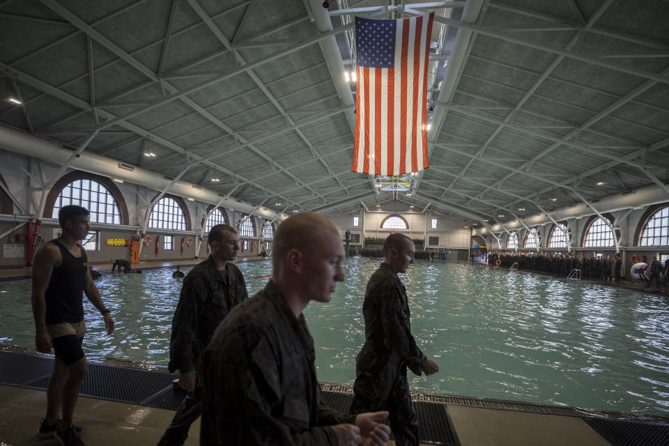 A group of male U.S. Marine Corps recruits walk past the Marine Corps Recruit Depot pool during swim training, Wednesday, June 28, 2023, in Parris Island, S.C. (AP Photo/Stephen B. Morton)