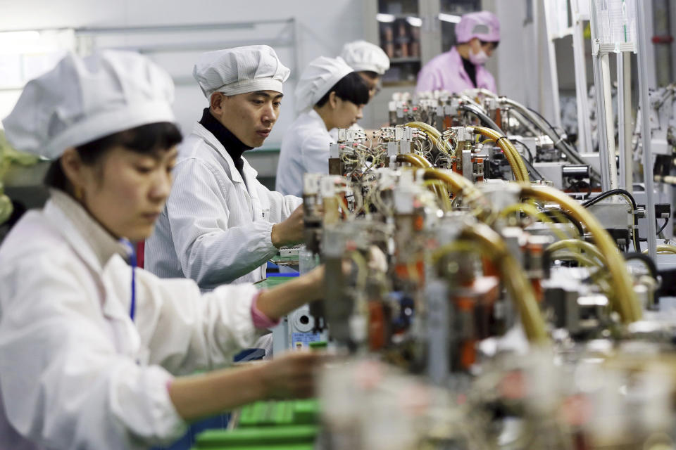 Trabajadores de una fábrica de motores en Huaibei, China. (Chinatopix via AP)