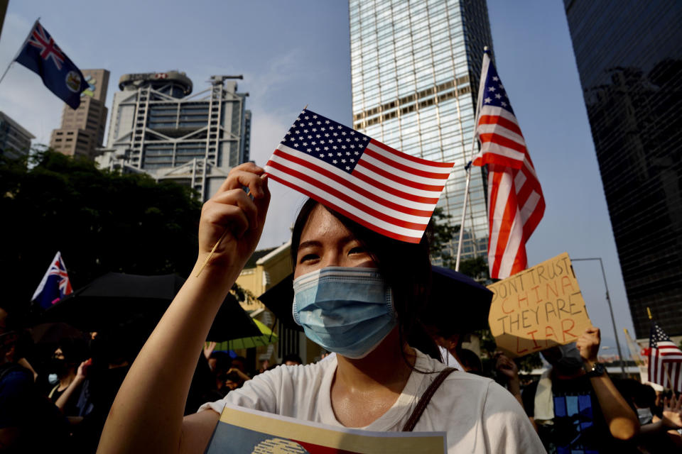 Protesters wave U.S. flags and shout slogans as they march from Chater Garden to the U.S. c\Consulate in Hong Kong, Sunday, Sept. 8, 2019. Demonstrators in Hong Kong plan to march to the U.S. Consulate on Sunday to drum up international support for their protest movement, a day after attempts to disrupt transportation to the airport were thwarted by police. (AP Photo/Vincent Yu)