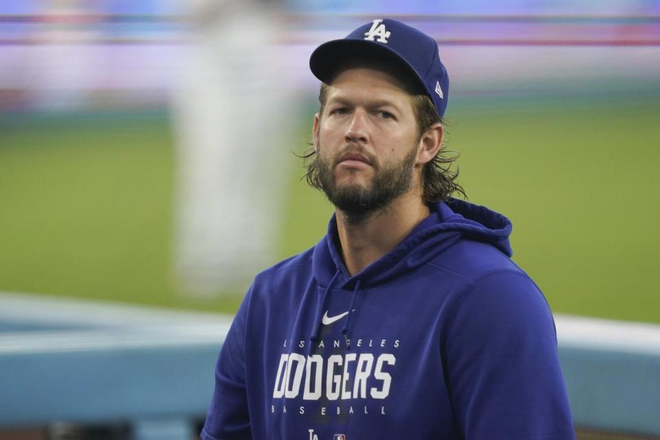 Dodgers pitcher Clayton Kershaw stands in the dugout before a game against the Arizona Diamondbacks on Aug. 30.