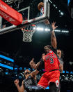 Chicago Bulls' Andre Drummond (3) shoots against Brooklyn Nets' Trendon Watford (9) and Noah Clowney, rear, during the first half of an NBA basketball game in New York, Friday, March 29, 2024. (AP Photo/Peter K. Afriyie)