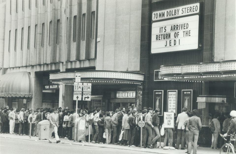 People wait outside a Canadian movie theater to buy tickets on May 25, 1983.