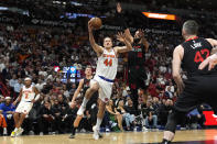 New York Knicks forward Bojan Bogdanovic (44) shoots as Miami Heat forward Caleb Martin (16) defends during the first half of an NBA basketball game, Tuesday, April 2, 2024, in Miami. (AP Photo/Lynne Sladky)