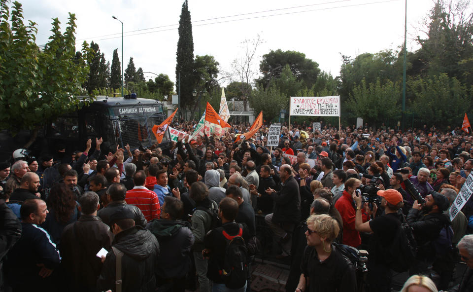 Municipal employees gather outside the Public Sector Reform ministry during a protest in Athens on Tuesday, Nov. 20, 2012. About 2,500 people took part in the protest, against government plans to place 2,000 civil servants on notice ahead of reassignment or potential dismissal. Greece faces a tense wait Tuesday for vital bailout money as finance ministers from the 17 European Union countries that use the euro try to reach an agreement on how to put the country's economic recovery back on the right track. (AP Photo/Thanassis Stavrakis)