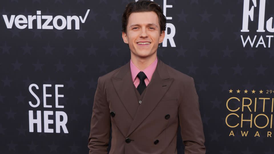 Tom Holland looked dapper in head-to-toe Prada, with a pink poplin shirt adding a pop of color to his all-brown suit. - Jordan Strauss/Invision/AP