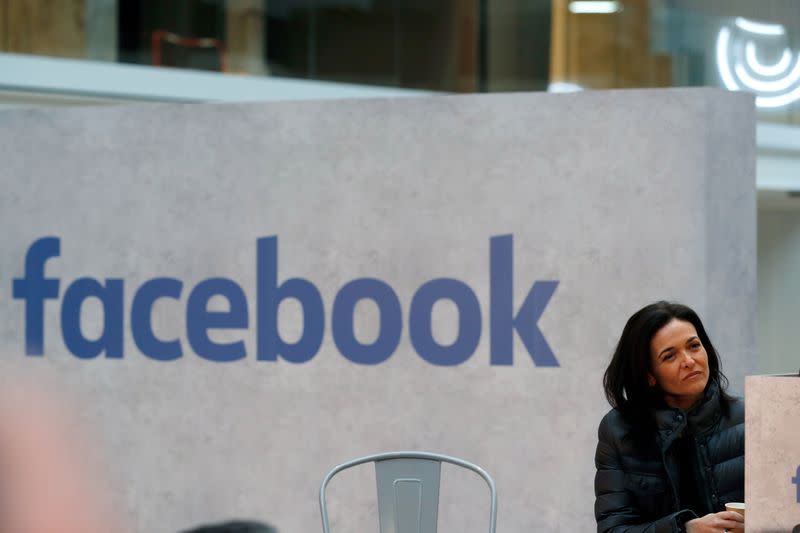 FILE PHOTO: Sheryl Sandberg, chief operating officer of Facebook, listens to a speeches during a visit in Paris