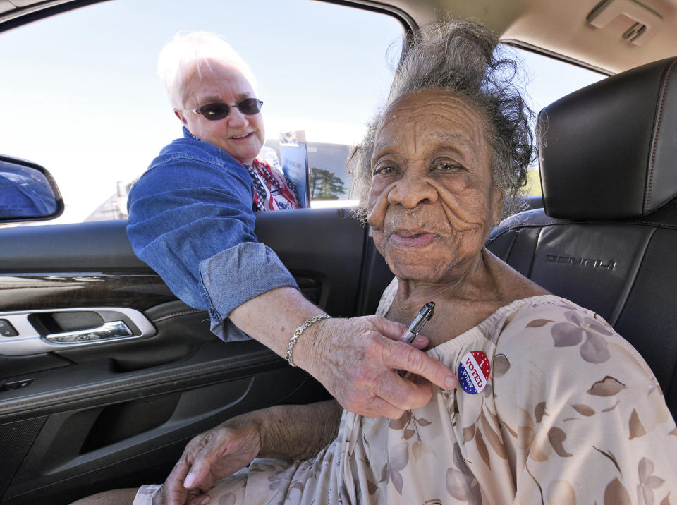 100 year old Grace Bell Hardison receives an “I Voted Today” sticker from election official Elain