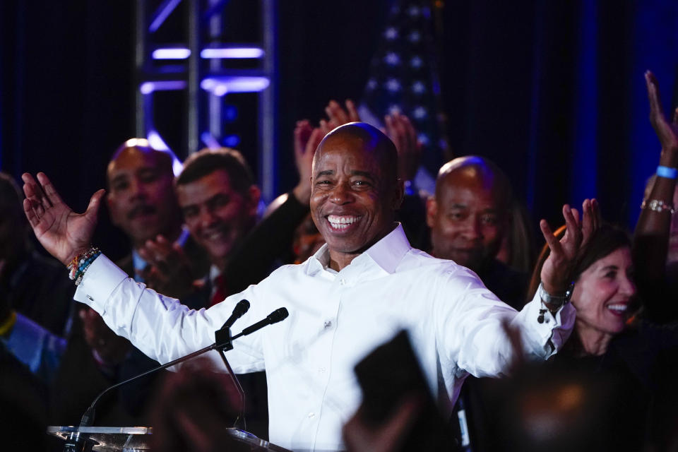 FILE - New York City Mayor-elect Eric Adams acknowledge the cheers of supporters following his election win as the city's next mayor, Tuesday, Nov. 2, 2021, in New York. Adam's election comes at a time when Black elected officials hold a historic number of city, state and federal offices in New York. When New Yorkers this week chose Eric Adams as their next mayor and Alvin Bragg as the next Manhattan district attorney, they elevated two more Black men into high office at a time when the city and state are being led by a historic number of Black leaders.(AP Photo/Frank Franklin II, File)