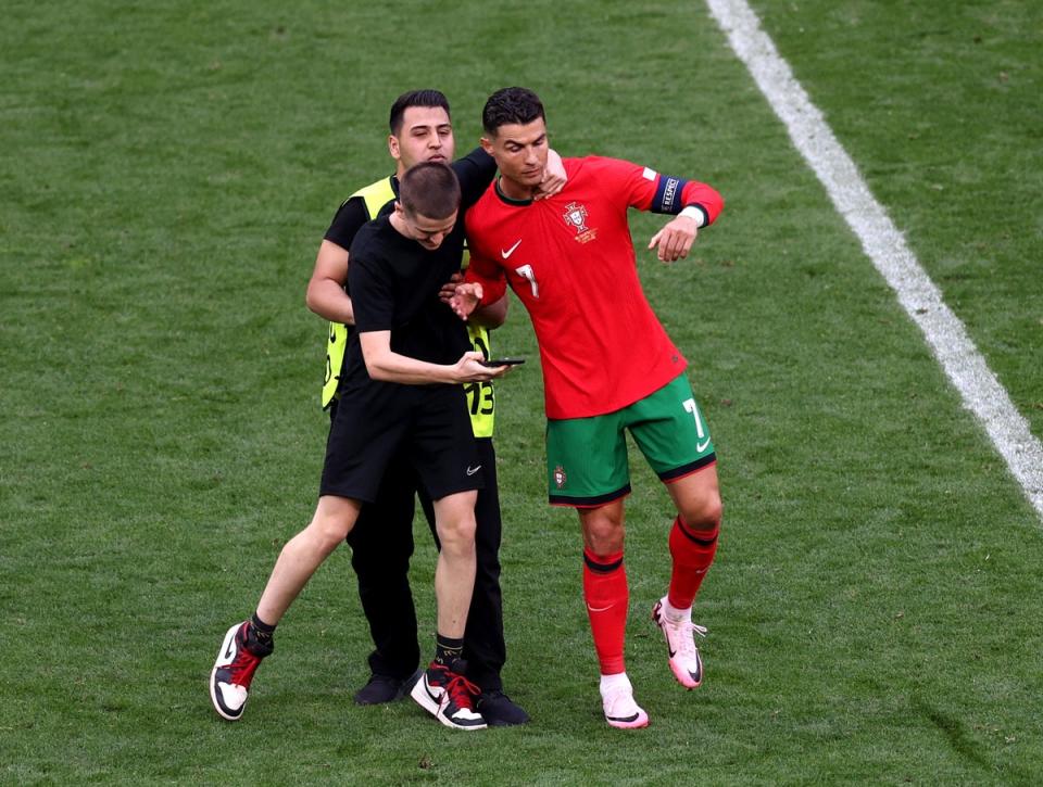 But the next pitch invader managed to reach Ronaldo and grabbed him (Getty Images)