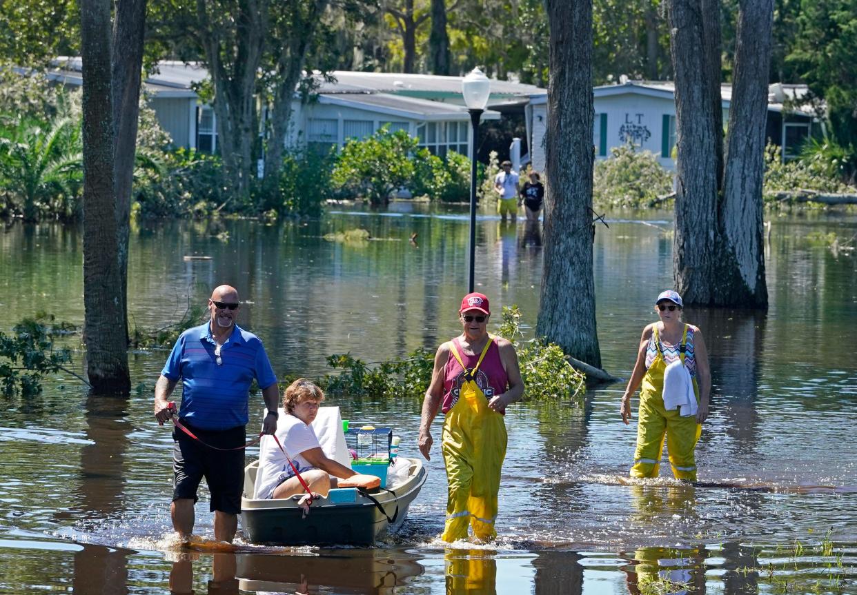 Residents of Colony in the Wood  and their pets are rescued from the flooded mobile home park in Port Orange on Oct. 1, after Tropical Storm Ian's destructive winds and torrential rains pounded Volusia County.