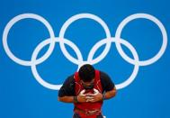 Azerbaijan's Intigam Zairov gestures after successful lift on the men's 94Kg group A weightlifting competition at the ExCel venue at the London 2012 Olympic Games August 4, 2012. REUTERS/Dominic Ebenbichler