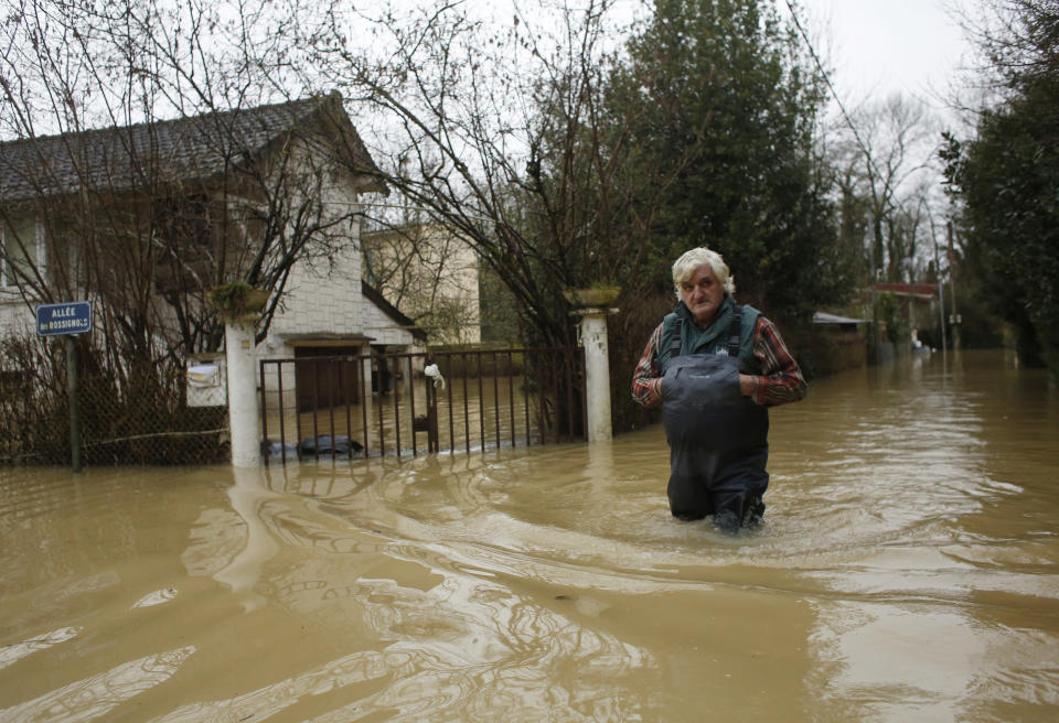 <p>A resident walks in a flooded street of Esbly, east of Paris, where the Grand Morin river floods Thursday, Jan.25, 2018. (Photo: Thibault Camus/AP) </p>