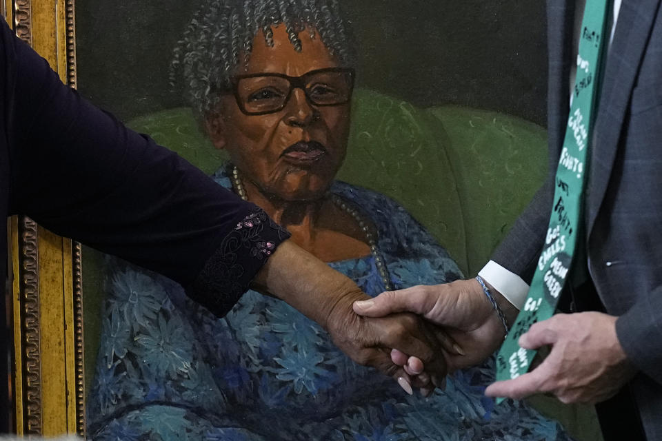 Opal Lee, left, who worked to help make Juneteenth a federally-recognized holiday, holds they hand of stete Sen. Drew Springer, right after her portrait was unveiled in the Texas Senate Chamber, Wednesday, Feb. 8, 2023, in Austin, Texas. (AP Photo/Eric Gay)