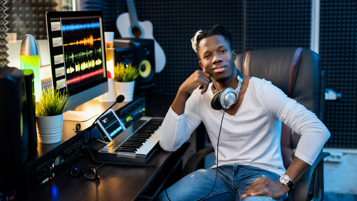  Man sits in his home recording studio. 