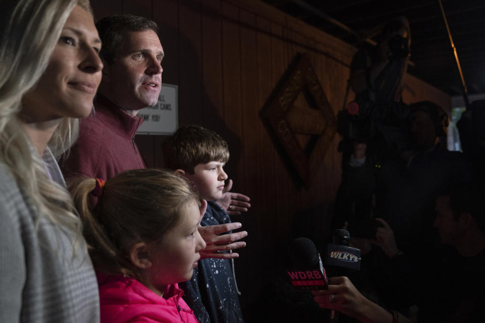 Kentucky Attorney General and Democratic Gubernatorial candidate Andy Beshear stands with his family while speaking with the media after voting Tuesday, Nov. 5, 2019, in Louisville, Ky. (AP Photo/Bryan Woolston)