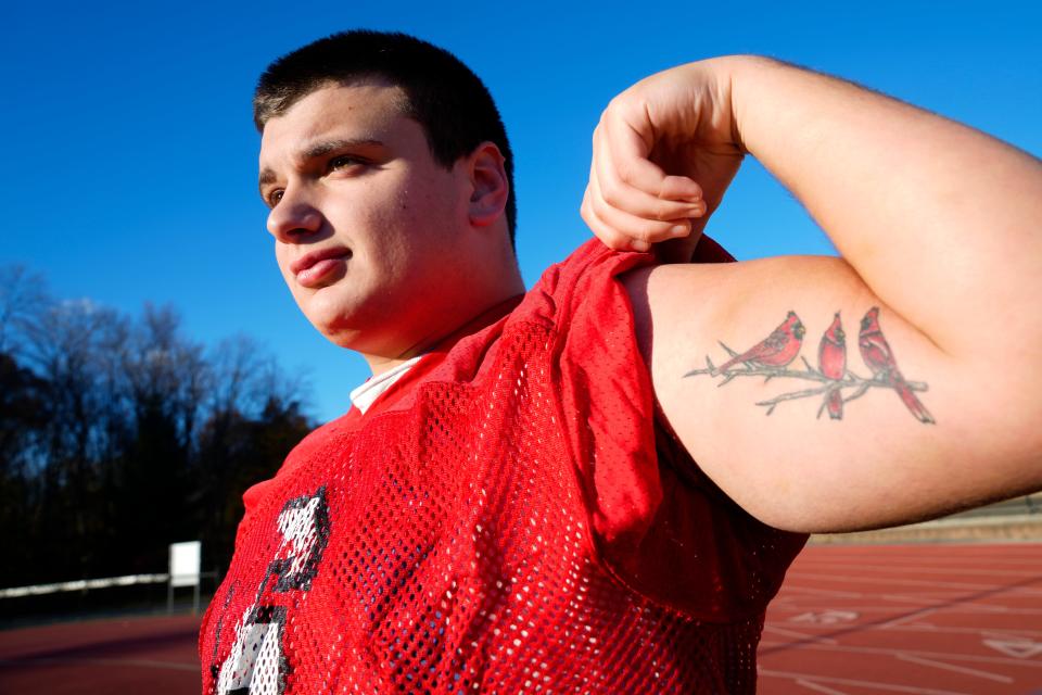 RJ Ussher, of the Westwood High School Football Team, poses with his tattoo of three Cardinals. Each bird represents someone in his life who has died in the past few years, Ussher lost his father, aunt and a teammate. Tuesday, November 14, 2023