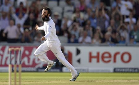 England's Moeen Ali celebrates after dismissing India's Mahendra Singh Dhoni during the fourth test cricket match at Old Trafford cricket ground at Manchester August 9, 2014. REUTERS/Philip Brown