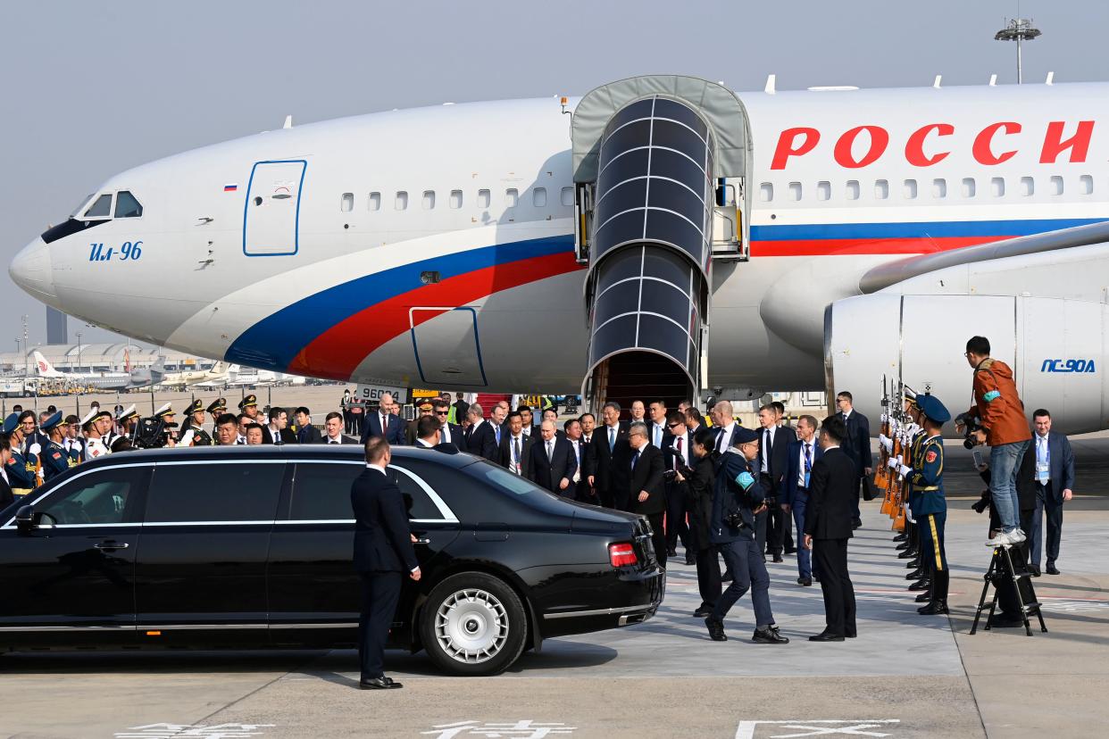 Russia’s President Vladimir Putin, center, arrives at Beijing Capital International Airport (AP)