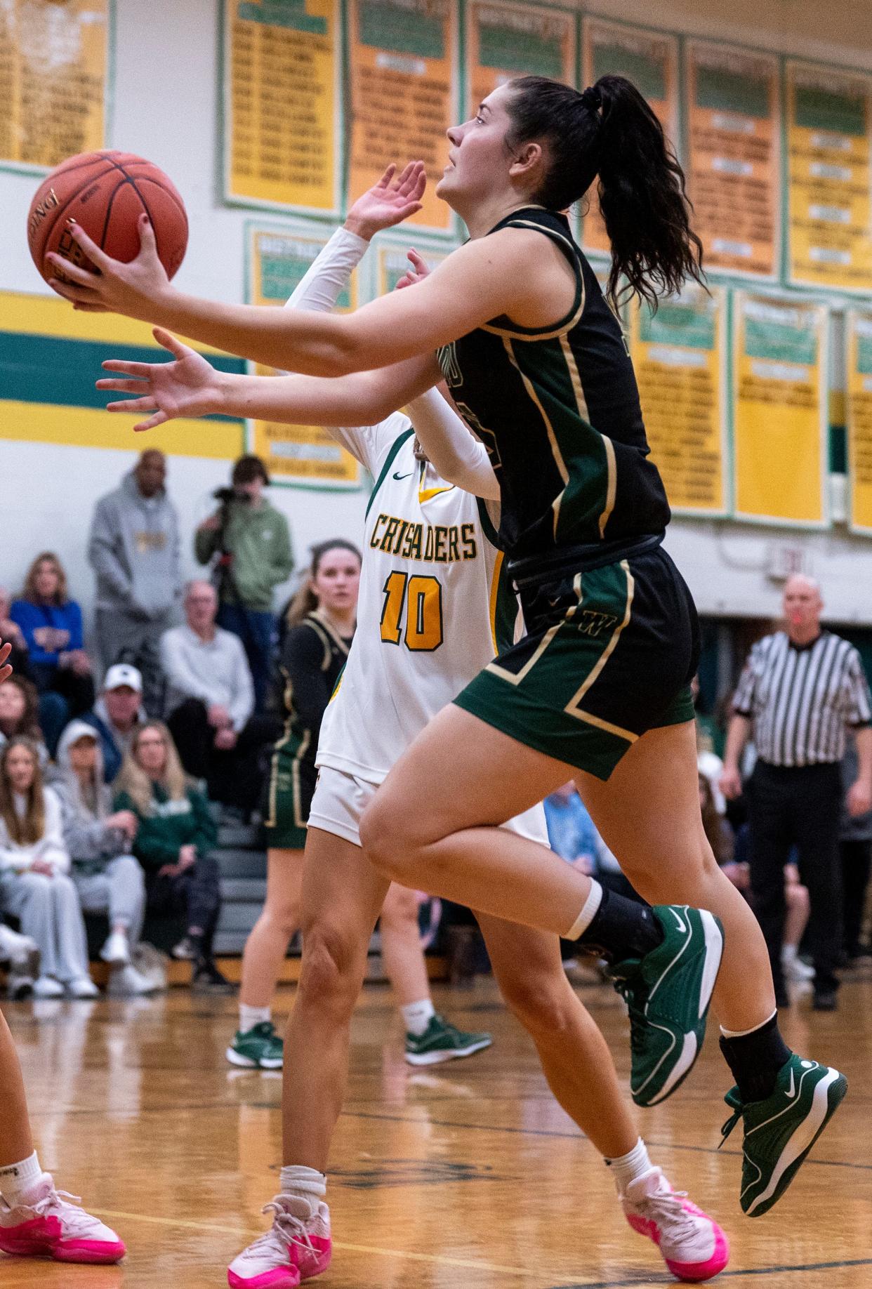 Archbishop Wood's Emily Knouse (30) goes for a lay-up against Lansdale Catholic's Nadia Yemola (10) during their girls' basketball game in Lansdale on Tuesday, Jan. 23, 2024.

Daniella Heminghaus | Bucks County Courier Times