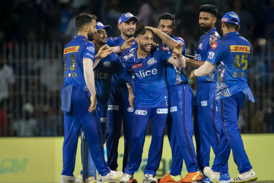 Mumbai Indians' Akash Madhwal, center, is congratulated by teammates as they celebrate their team's win against Lucknow Super Giants during the Indian Premier League cricket eliminator match in Chennai, India, Wednesday, May 24, 2023. (AP Photo /R. Parthibhan)