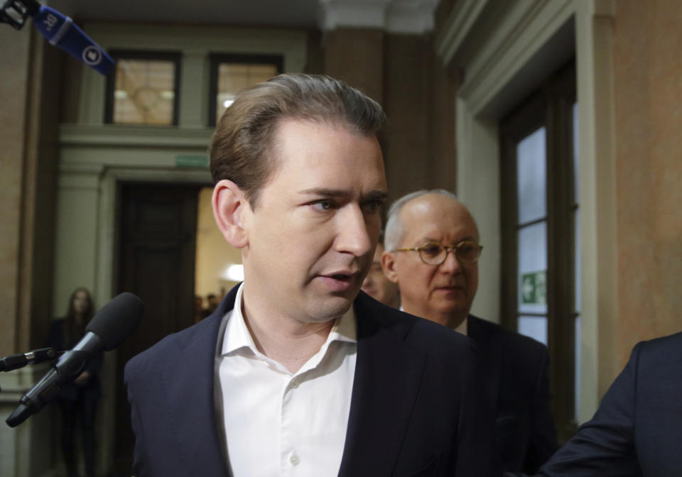Former Austrian Chancellor Sebastian Kurz, left, accompanied by his lawyer Walter Suppan, right, arrives at court on the first day of his trial in Vienna, Austria, Wednesday, Oct. 18, 2023. Kurz is charged with making false statements to a parliamentary inquiry into alleged corruption in his first government. (AP Photo/Heinz-Peter Bader)